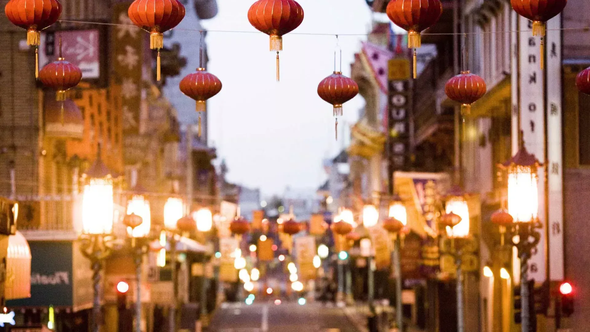 Close-up view of a string of red lanterns hanging above a street in Chinatown. San Francisco, California.